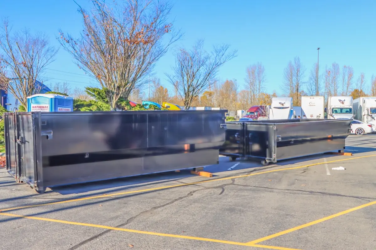 Professional dumpster rental service with roll-off container on residential driveway in Spokane Valley